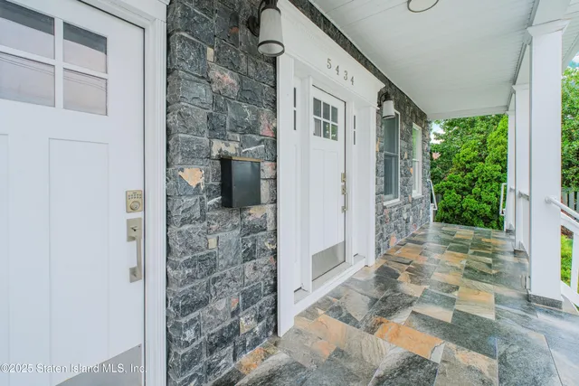 a front view of a house with a porch