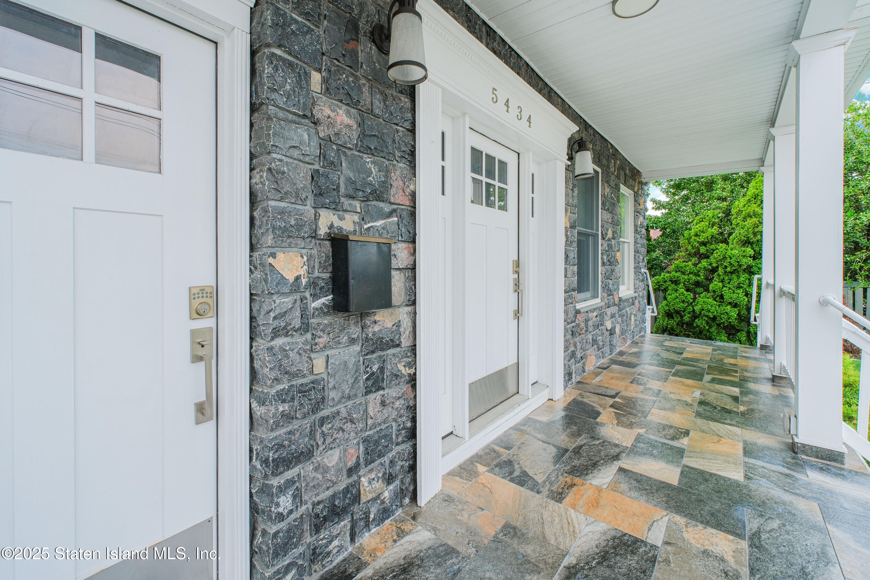 5434 Amboy Road Staten Island, NY 10312 - Photo 6 of 51 a front view of a house with a porch