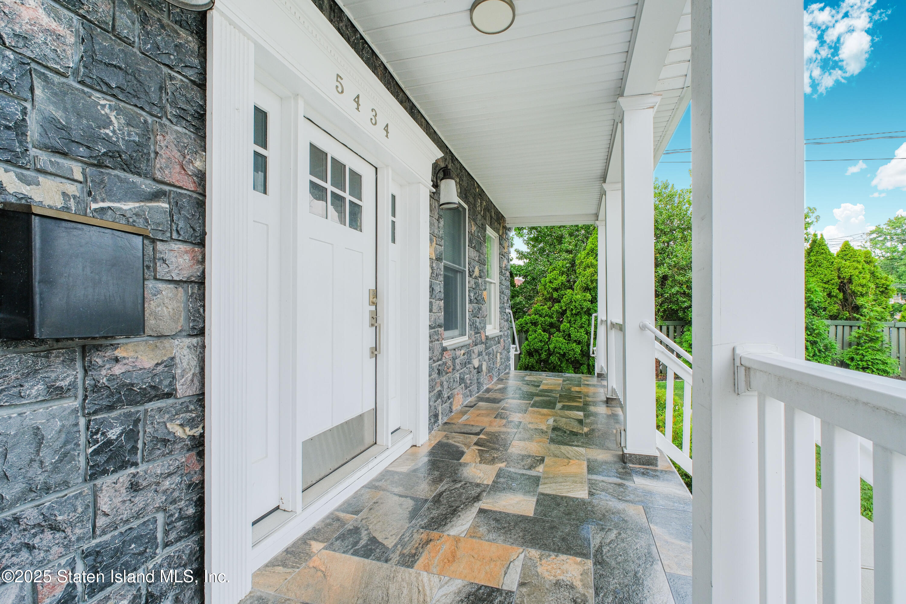 5434 Amboy Road Staten Island, NY 10312 - Photo 9 of 51 a front view of a house with a porch