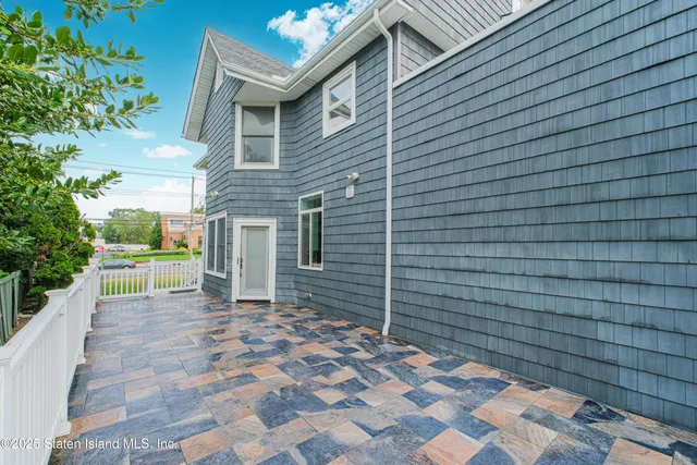 a pathway of a house with a small yard