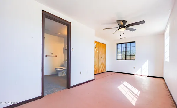 a large white kitchen with a sink and dishwasher with a large window