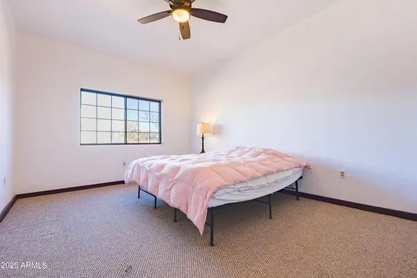 a view of an empty room with a window and fireplace