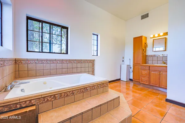 a kitchen with stainless steel appliances granite countertop a refrigerator stove and wooden cabinets