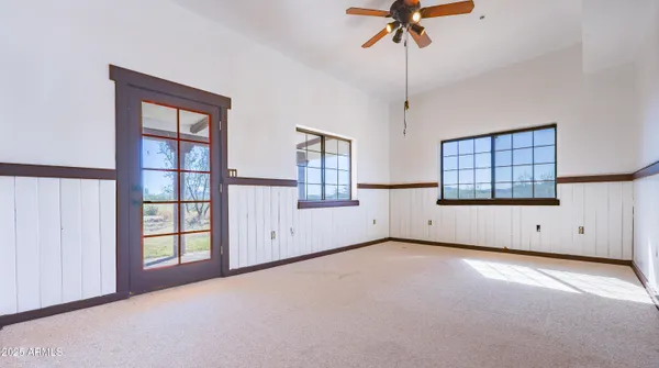 an empty room with closet and windows
