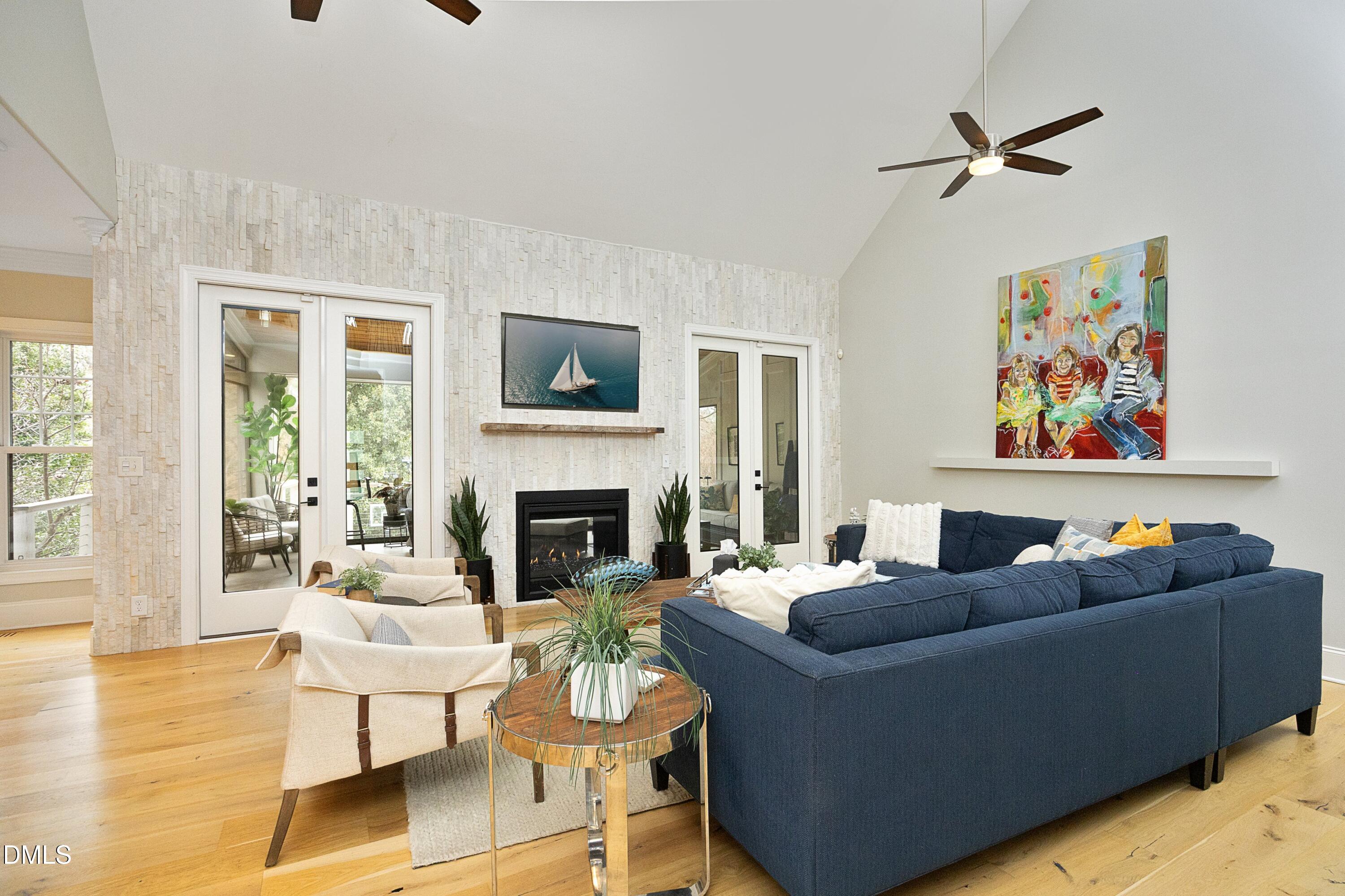 2608 St Marys Street Raleigh, NC 27609 - Photo 16 of 89 a living room with furniture a fireplace and a floor to ceiling window