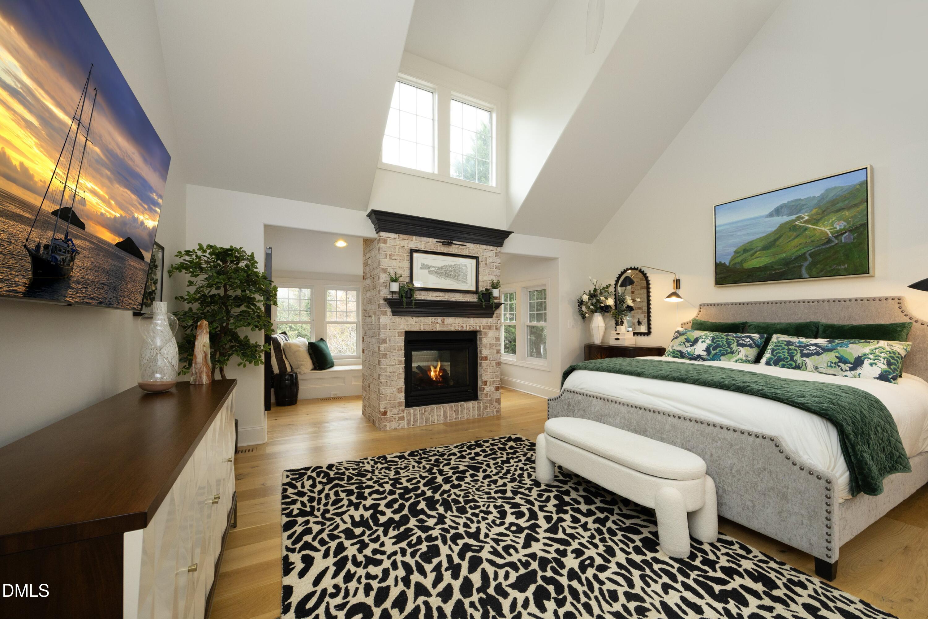 2608 St Marys Street Raleigh, NC 27609 - Photo 27 of 89 a bedroom with a bed a fireplace and potted plants with the wooden floor