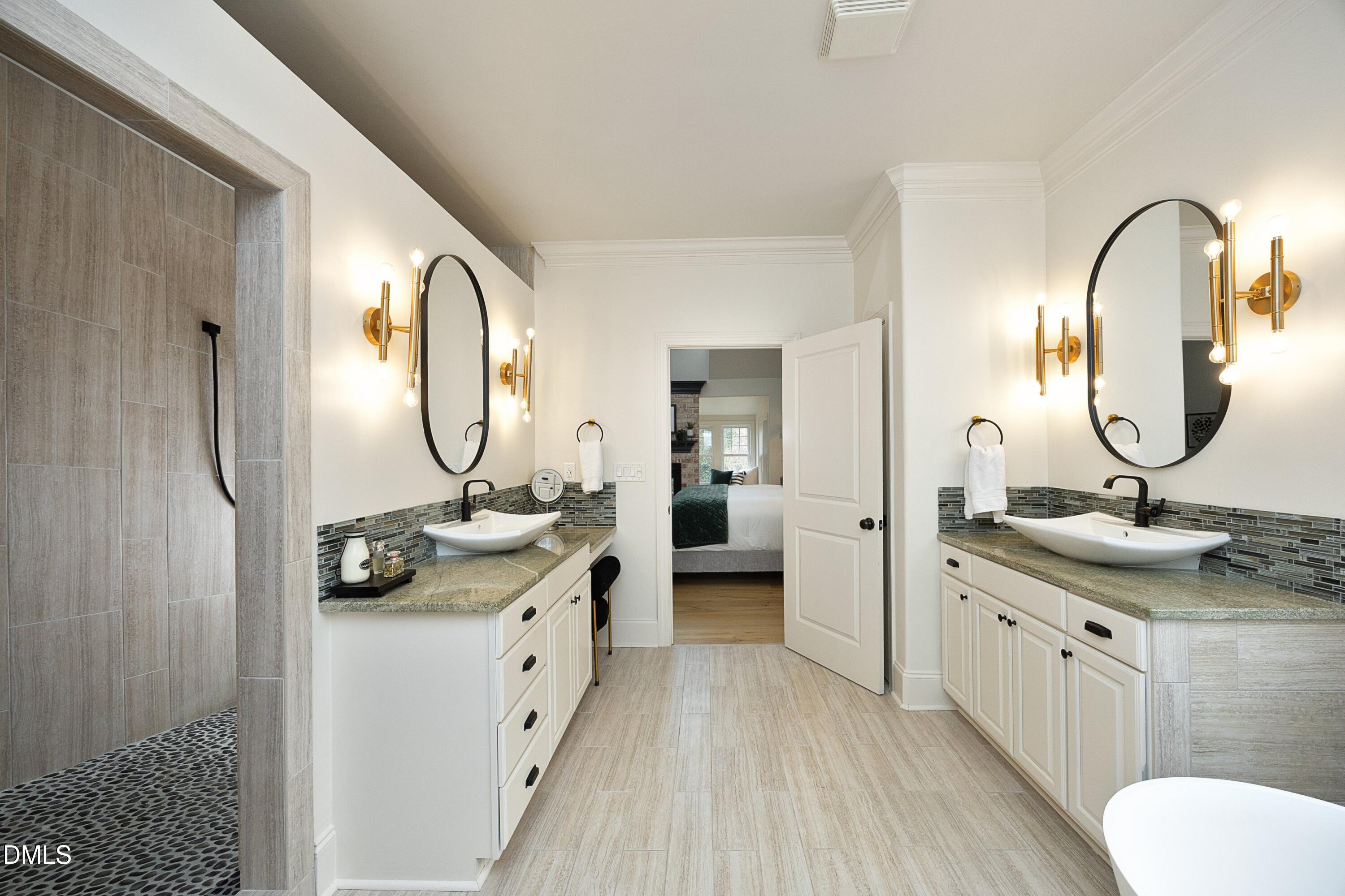 2608 St Marys Street Raleigh, NC 27609 - Photo 33 of 89 a en suite bathroom with a granite countertop sink and a mirror