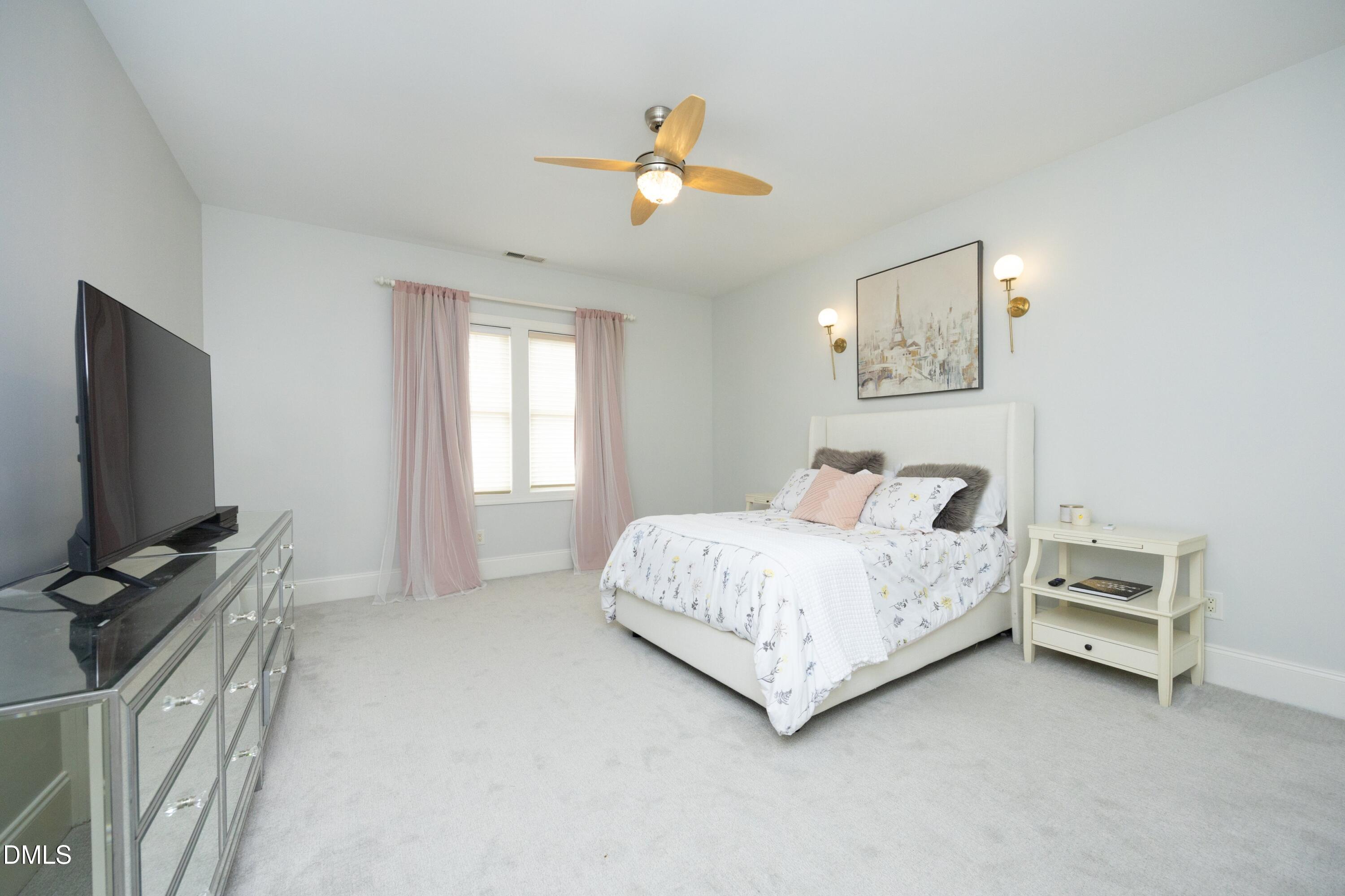 2608 St Marys Street Raleigh, NC 27609 - Photo 42 of 89 a bedroom with a bed and a flat screen tv