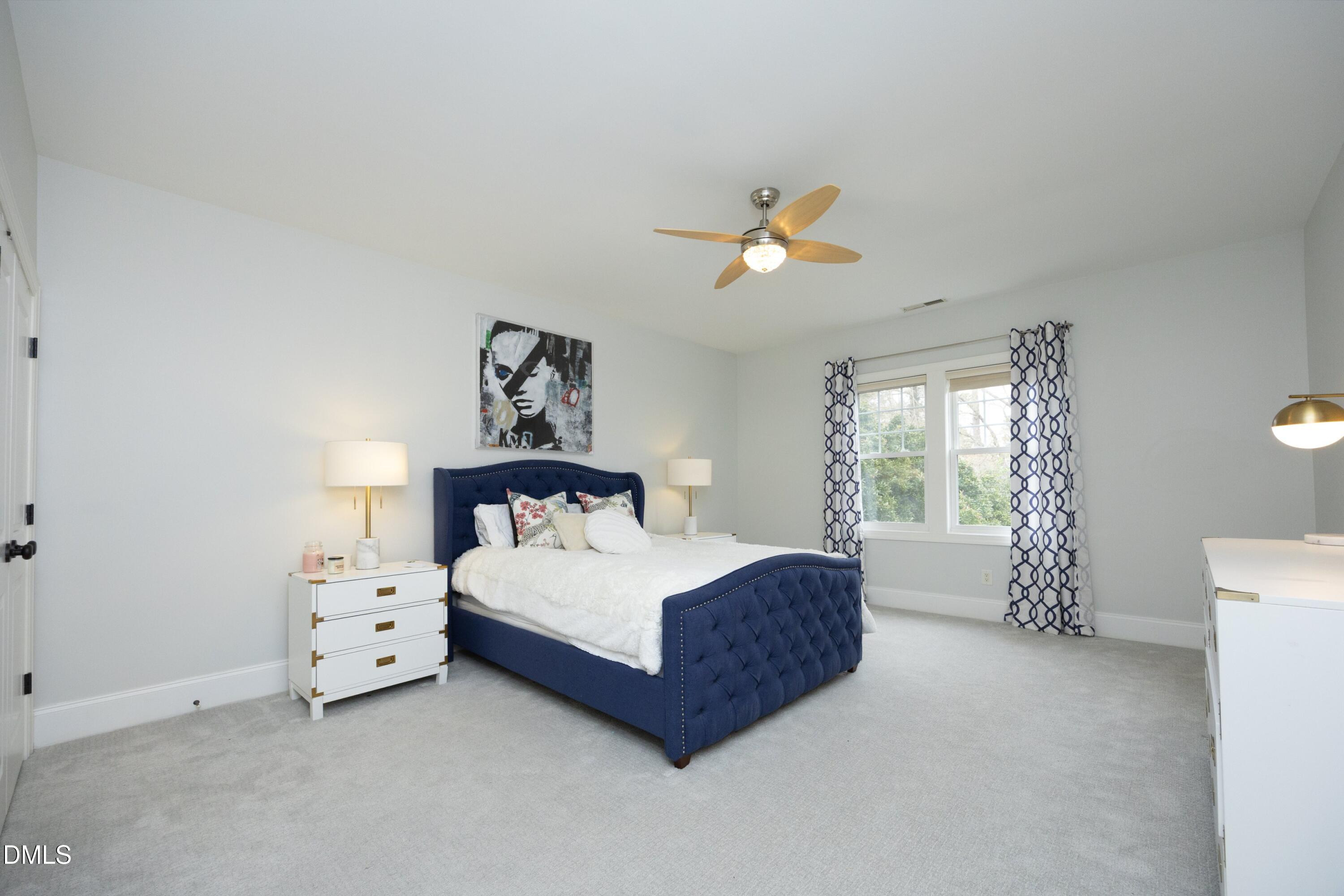 2608 St Marys Street Raleigh, NC 27609 - Photo 43 of 89 a bedroom with a bed and a chandelier