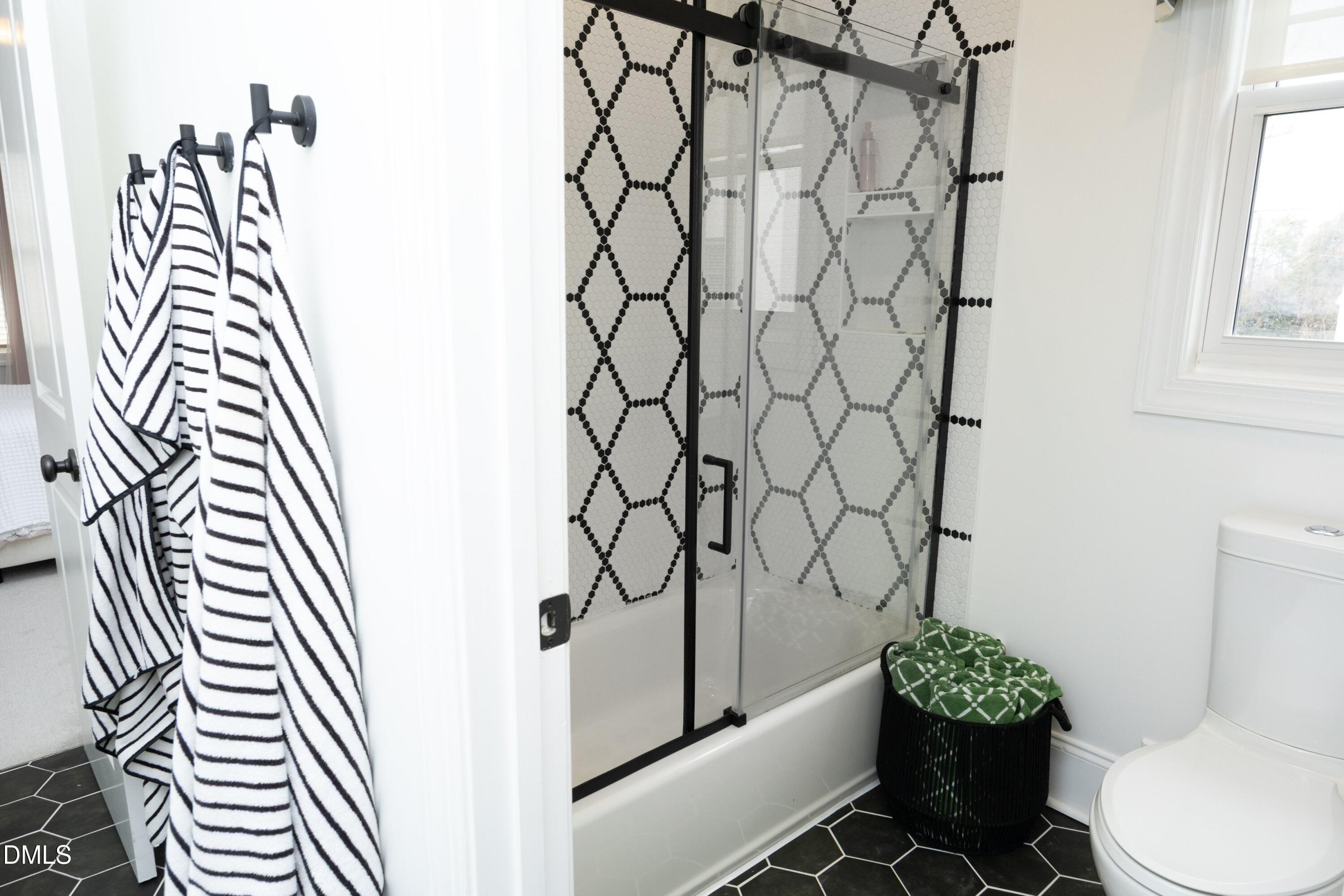 2608 St Marys Street Raleigh, NC 27609 - Photo 45 of 89 a bathroom with a toilet and a shower curtain