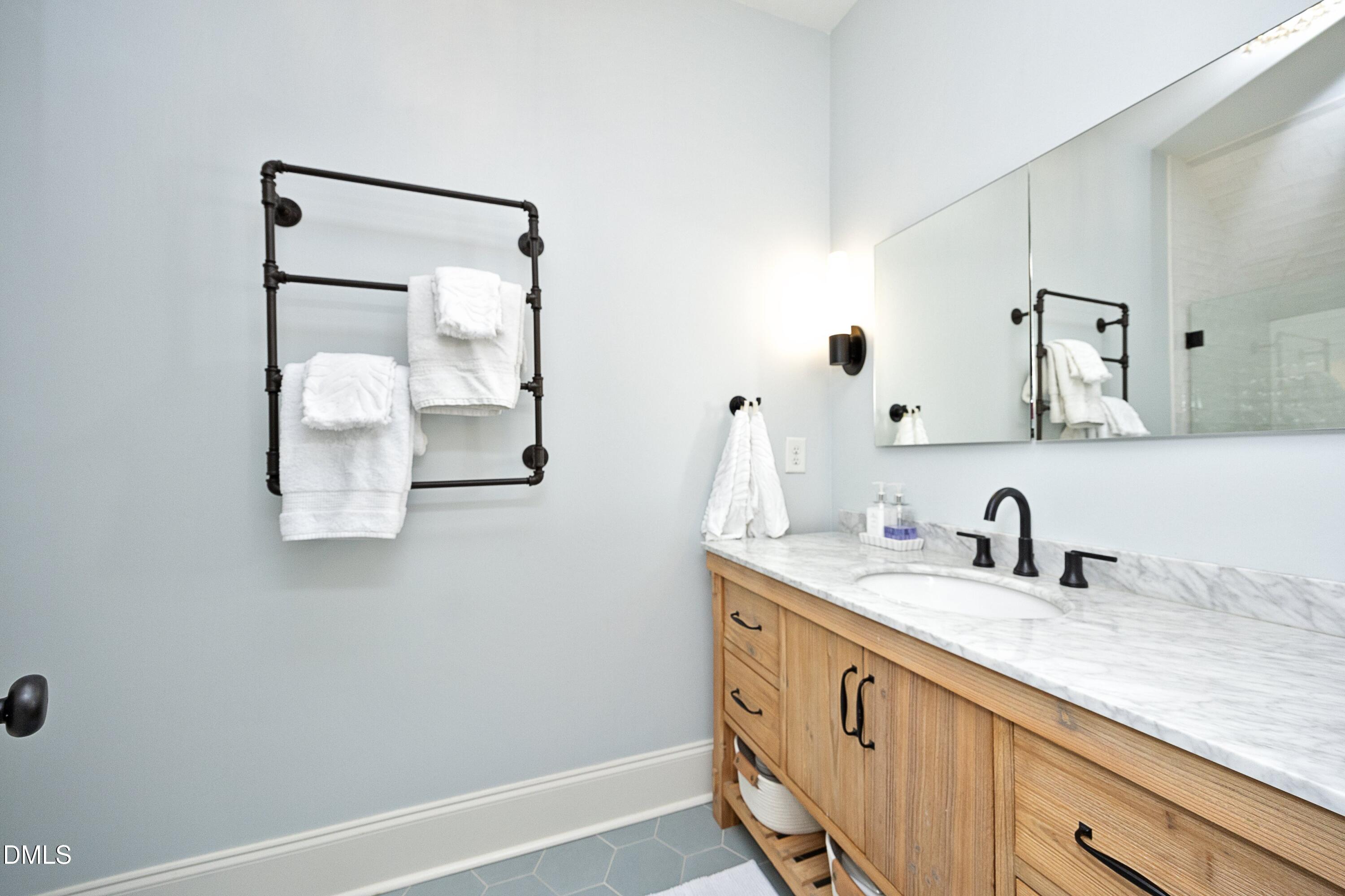 2608 St Marys Street Raleigh, NC 27609 - Photo 47 of 89 a bathroom with a sink and a mirror