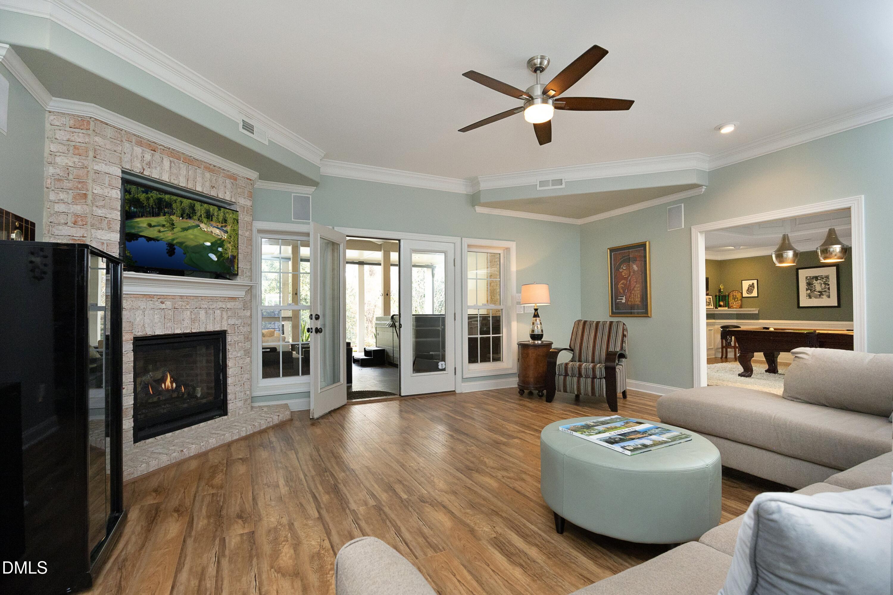 2608 St Marys Street Raleigh, NC 27609 - Photo 49 of 89 a living room with furniture a fireplace and a floor to ceiling window