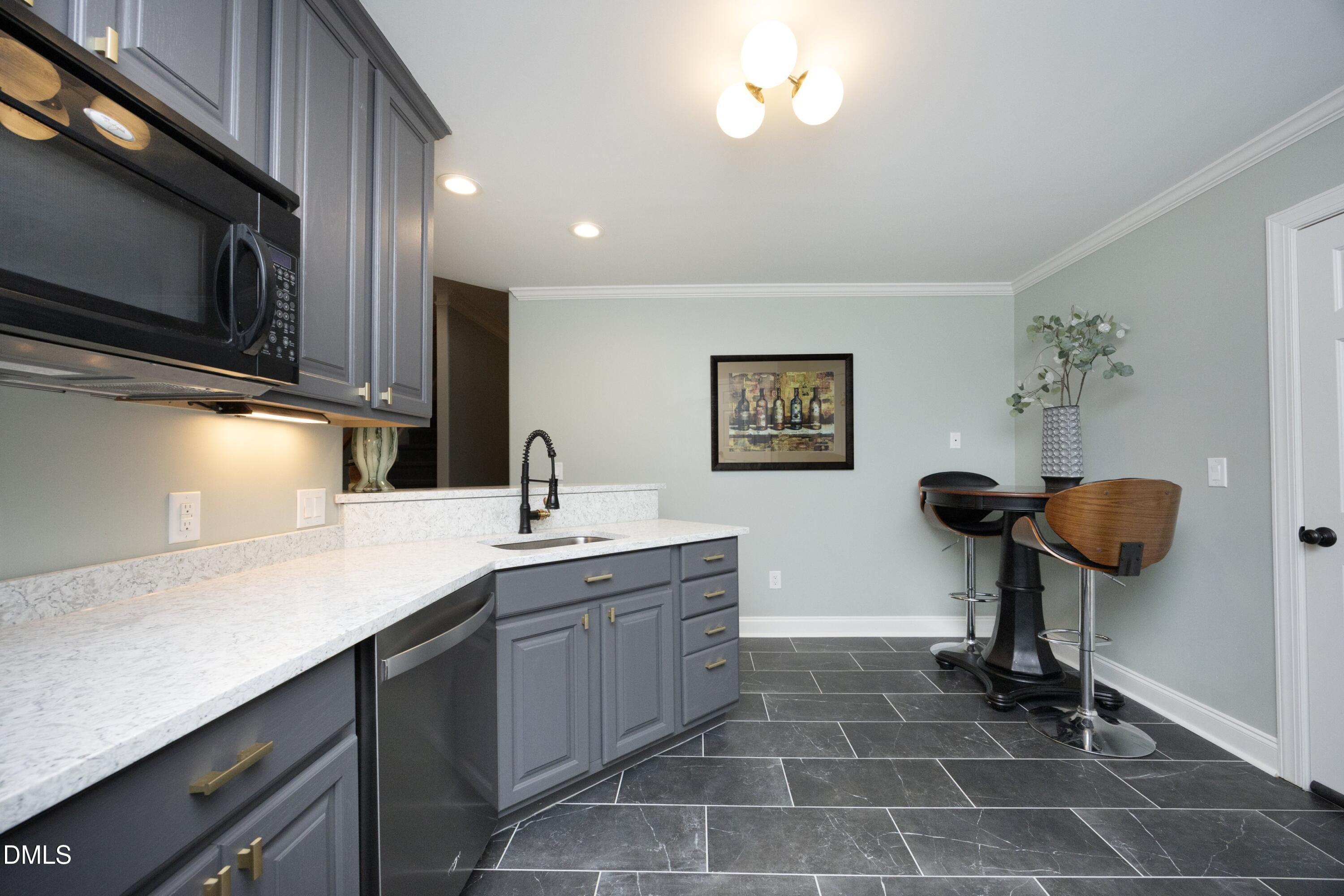 2608 St Marys Street Raleigh, NC 27609 - Photo 57 of 89 a kitchen with a sink cabinets and appliances