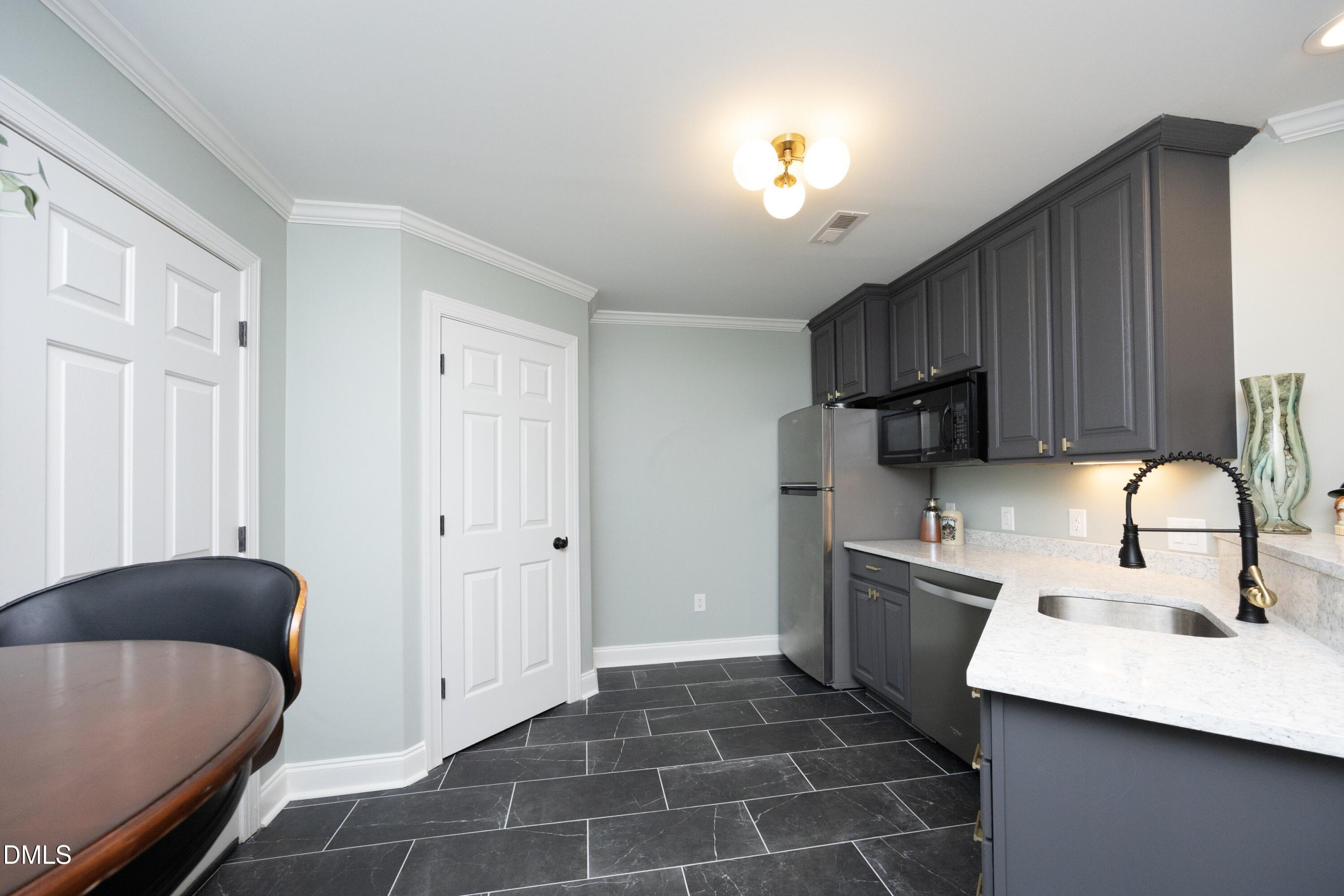 2608 St Marys Street Raleigh, NC 27609 - Photo 58 of 89 a kitchen with stainless steel appliances granite countertop a sink refrigerator and cabinets