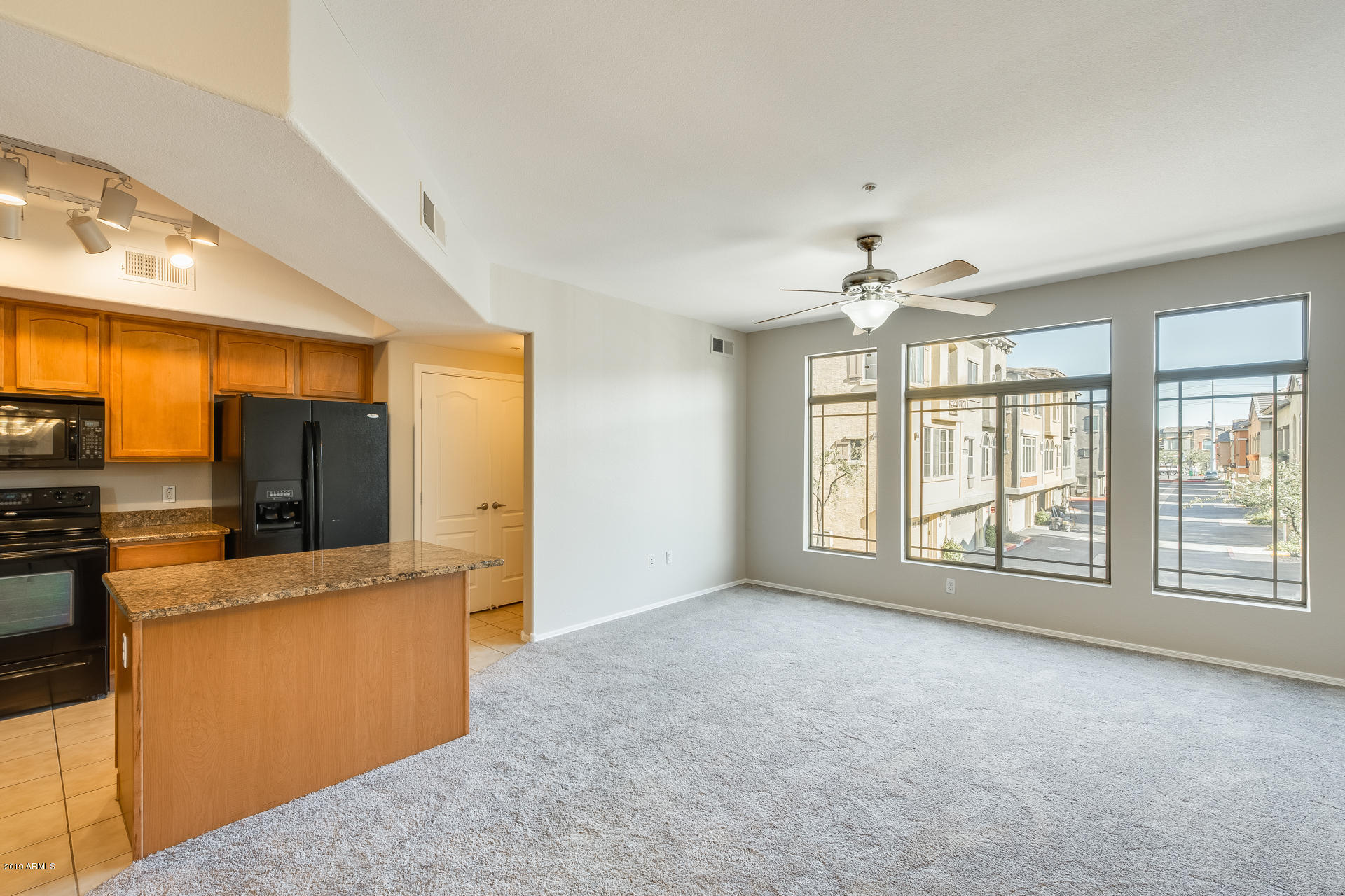 2401 East Rio Salado Parkway, Unit 1124 Tempe, AZ 85288 - Photo 17 of 32 a view of a kitchen with a sink cabinet and a living room