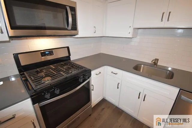 a kitchen with a stove and a microwave