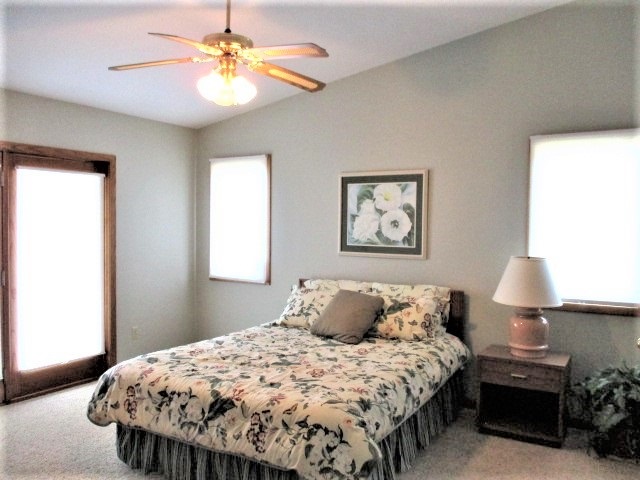 527 Baintree Road Lake Summerset, IL 61019 - Photo 11 of 36 a bedroom with a bed and a chandelier