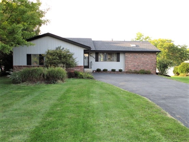 527 Baintree Road Lake Summerset, IL 61019 - Photo 2 of 36 a front view of a house with a garden and yard