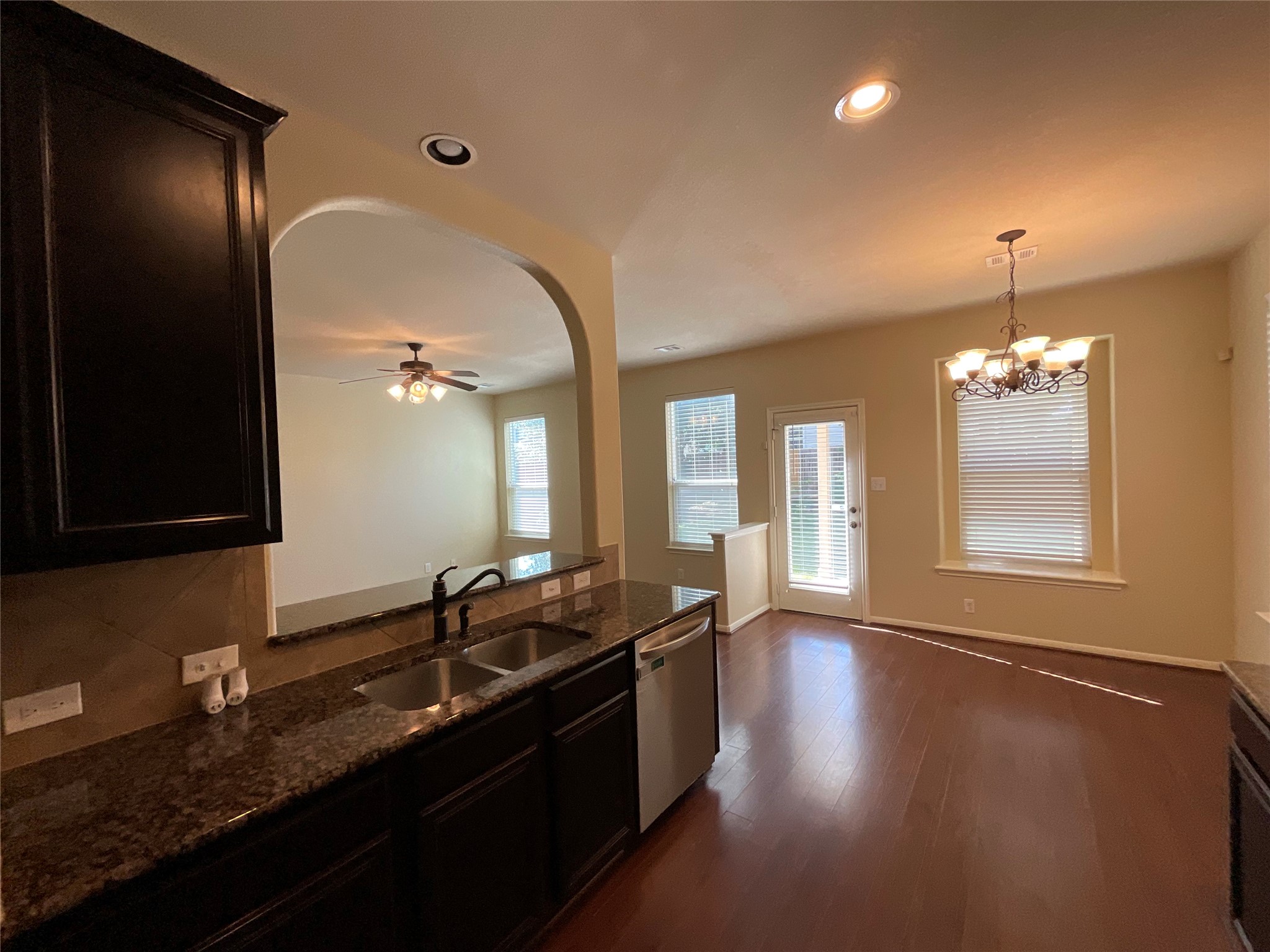 1911 Conn Creek Road Cedar Park, TX 78613 - Photo 20 of 39 a kitchen with granite countertop stainless steel appliances a sink stove and wooden floor