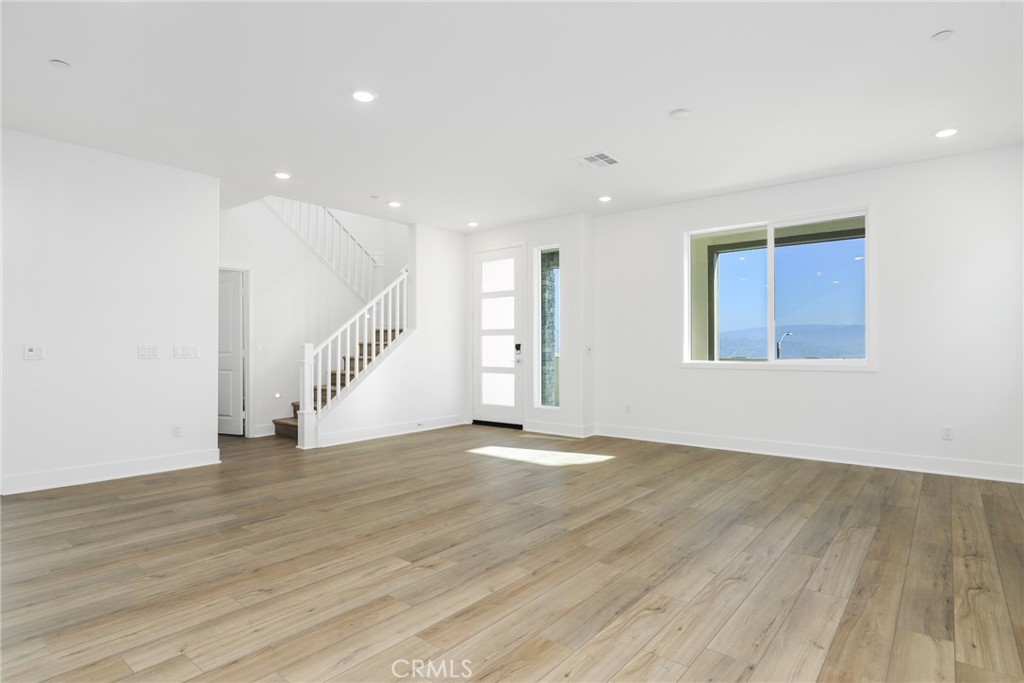 27213 Tamarack Lane Valencia, CA 91381 - Photo 17 of 40 a view of an empty room with wooden floor and staircase