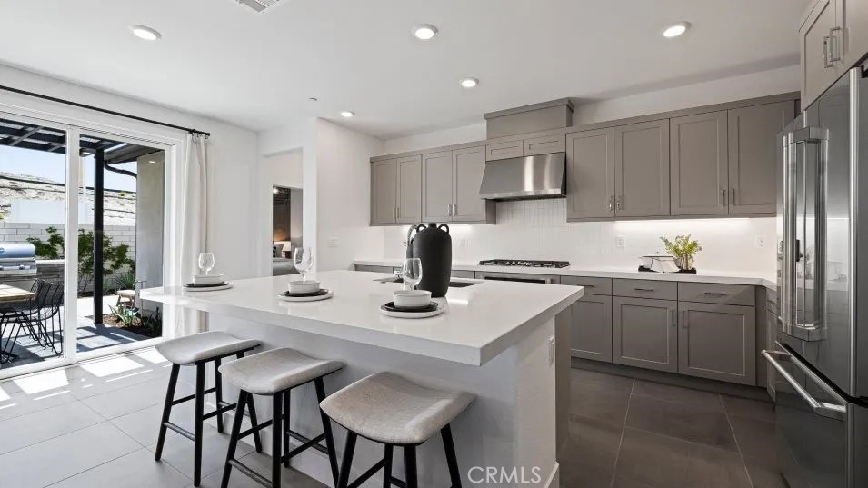 27213 Tamarack Lane Valencia, CA 91381 - Photo 2 of 40 a kitchen with stainless steel appliances granite countertop a sink and a refrigerator