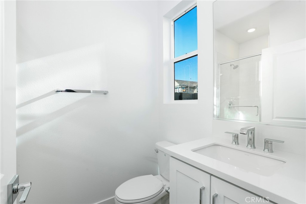 27213 Tamarack Lane Valencia, CA 91381 - Photo 21 of 40 a bathroom with a granite countertop sink toilet and mirror