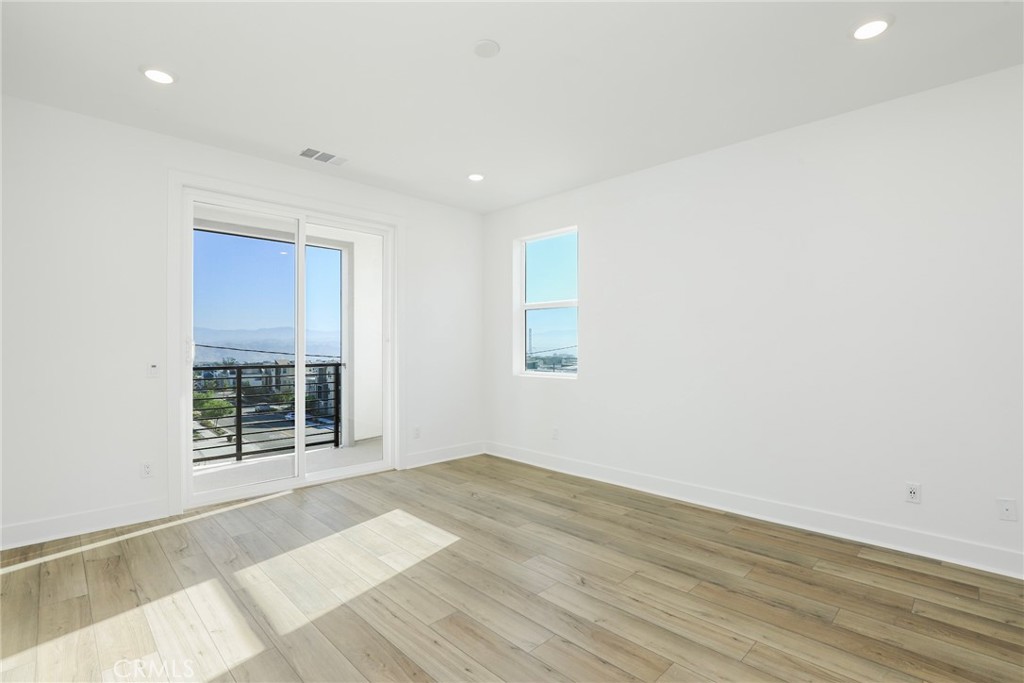 27213 Tamarack Lane Valencia, CA 91381 - Photo 23 of 40 an empty room with wooden floor and windows