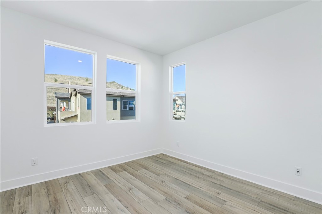 27213 Tamarack Lane Valencia, CA 91381 - Photo 24 of 40 a view of an empty room with wooden floor and a window