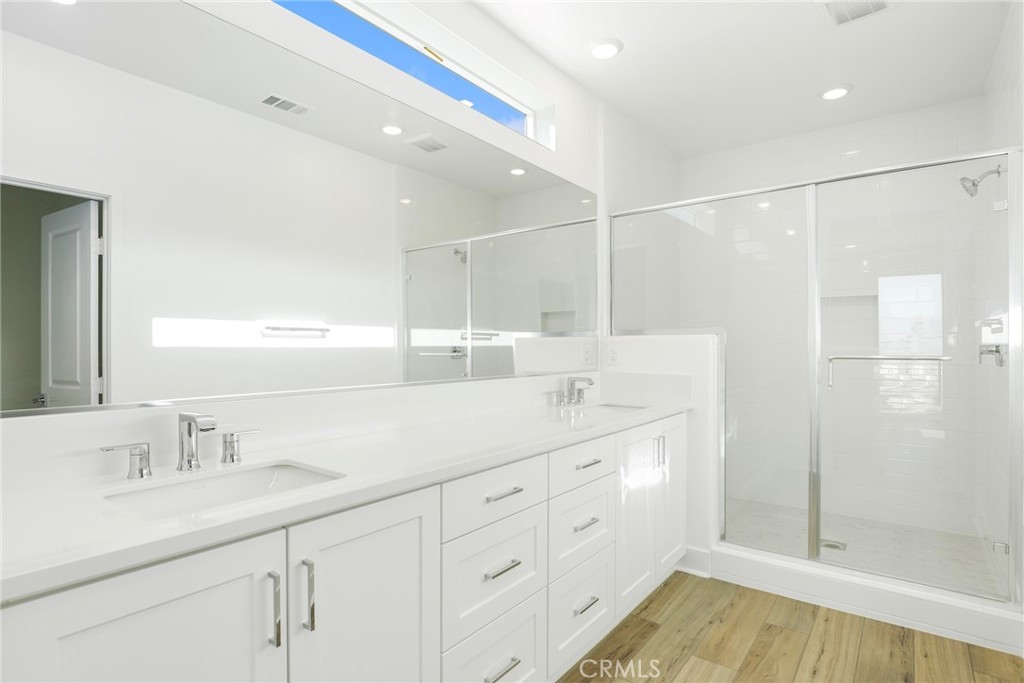 27213 Tamarack Lane Valencia, CA 91381 - Photo 27 of 40 a bathroom with a double vanity sink mirror and shower