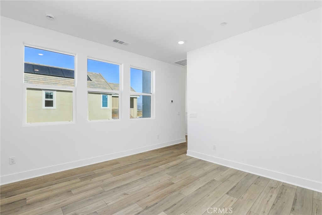 27213 Tamarack Lane Valencia, CA 91381 - Photo 30 of 40 a view of an empty room with wooden floor and a window
