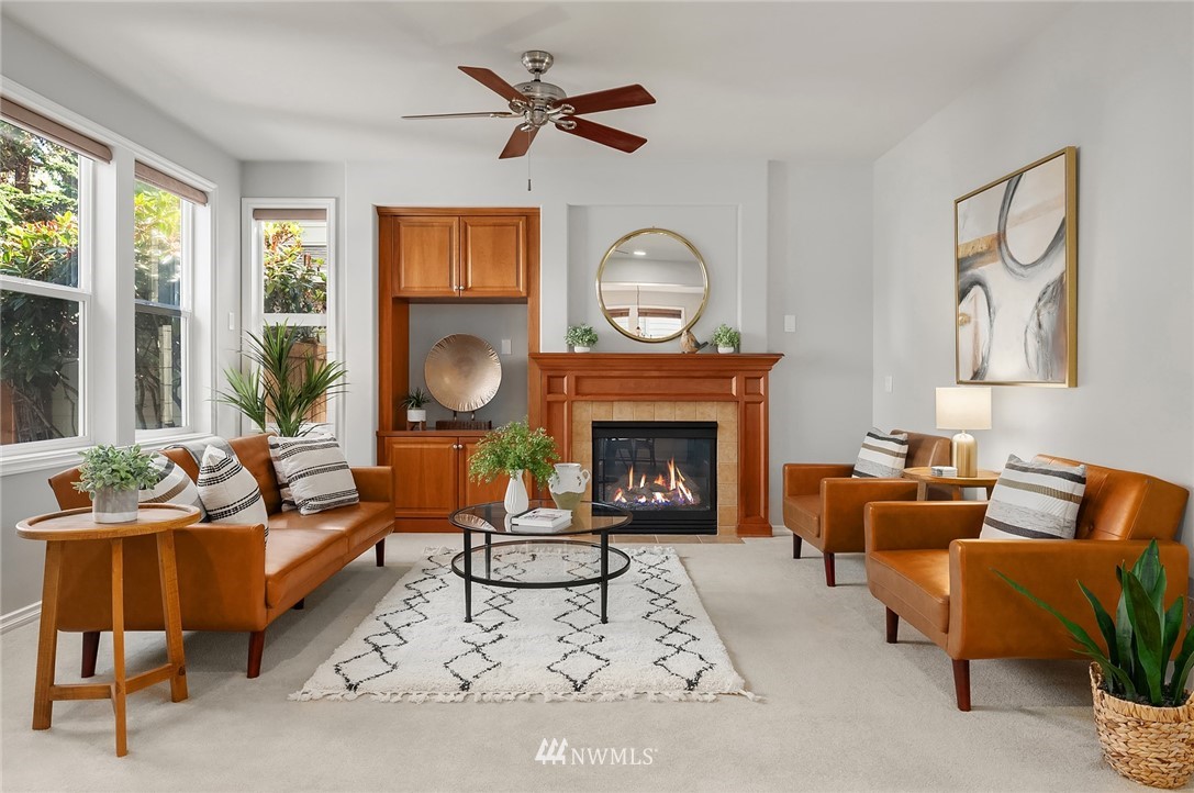 17018 166th Place Southeast Renton, WA 98058 - Photo 11 of 34 a living room with furniture a large window and a fireplace