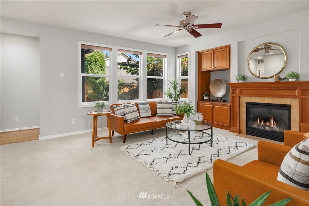 17018 166th Place Southeast Renton, WA 98058 - Photo 13 of 34 a living room with furniture a fireplace and a large window