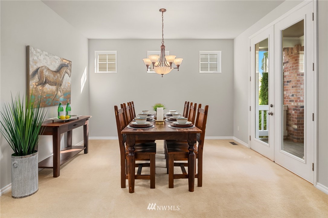 17018 166th Place Southeast Renton, WA 98058 - Photo 15 of 34 a view of a dining room with furniture and chandelier