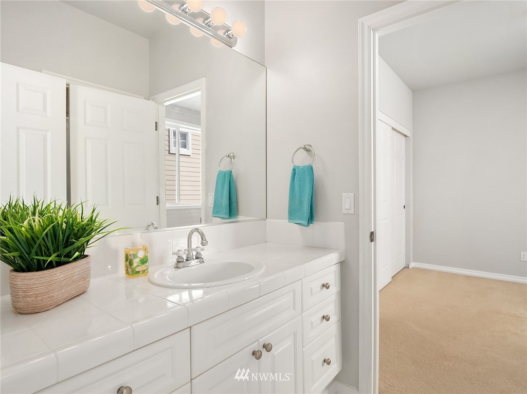 17018 166th Place Southeast Renton, WA 98058 - Photo 25 of 34 a bathroom with a sink a vanity and a mirror
