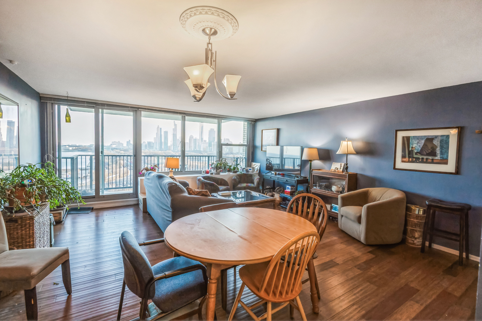 400 East Randolph Street, Unit 1515 Chicago, IL 60601 - Photo 6 of 50 a living room with furniture a chandelier and a dining table