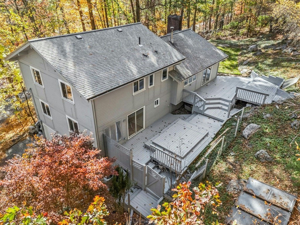 an aerial view of a house with a yard and large trees