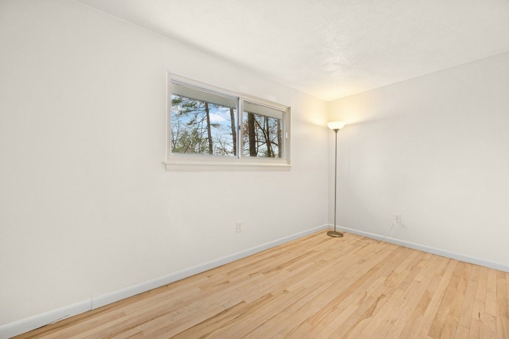 245 Brewer Street Northborough, MA 01532 - Photo 16 of 38 an empty room with wooden floor and window