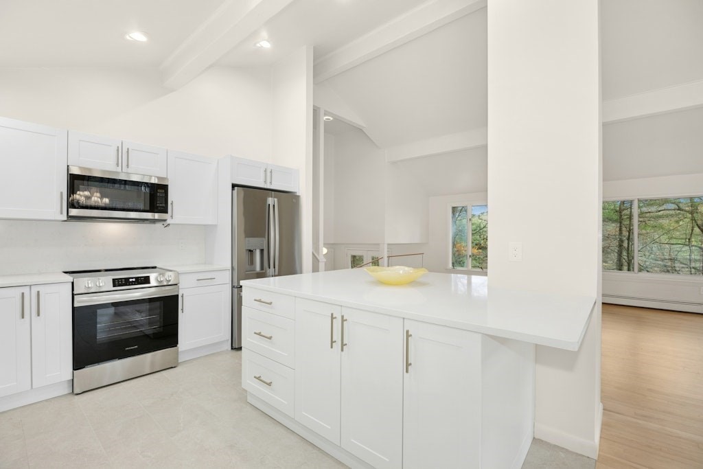 245 Brewer Street Northborough, MA 01532 - Photo 8 of 38 a kitchen with cabinets stainless steel appliances and wooden floor