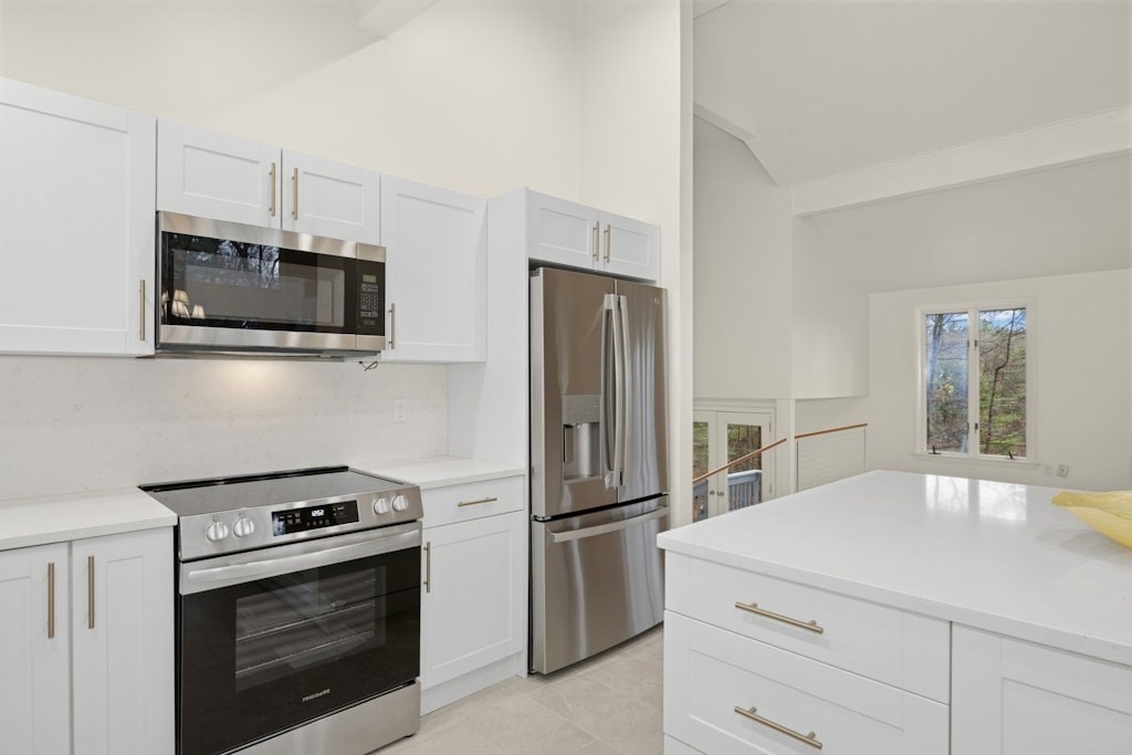245 Brewer Street Northborough, MA 01532 - Photo 9 of 38 a kitchen with stainless steel appliances a stove microwave and a refrigerator