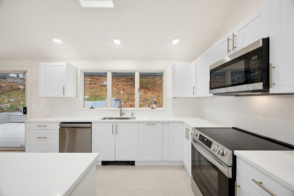 245 Brewer Street Northborough, MA 01532 - Photo 10 of 38 a kitchen with a sink stove and microwave
