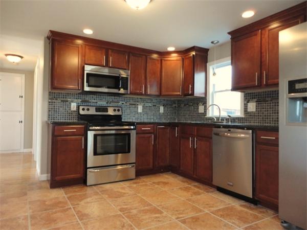 21 Anne Street Springfield, MA 01104 - Photo 1 of 27 a kitchen with stainless steel appliances granite countertop a stove a sink and a microwave