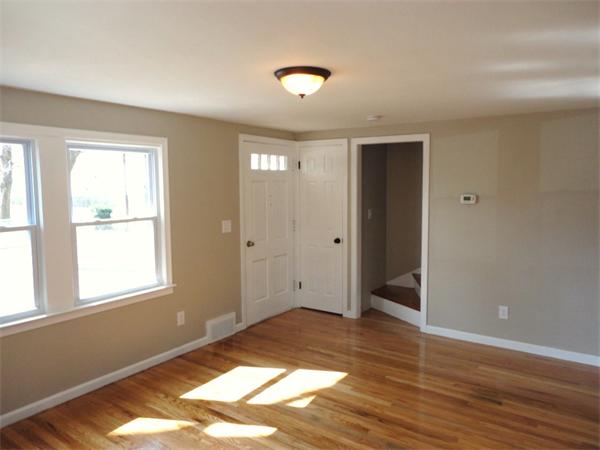 21 Anne Street Springfield, MA 01104 - Photo 12 of 27 an empty room with wooden floor and windows