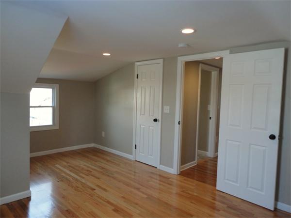 21 Anne Street Springfield, MA 01104 - Photo 15 of 27 an empty room with wooden floor and windows