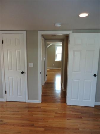 21 Anne Street Springfield, MA 01104 - Photo 17 of 27 a view of a hallway with wooden floor