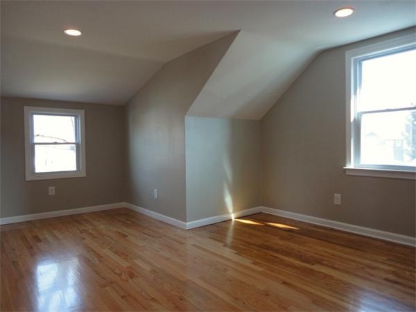 21 Anne Street Springfield, MA 01104 - Photo 18 of 27 an empty room with wooden floor and windows