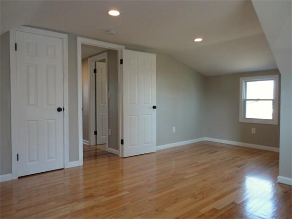 21 Anne Street Springfield, MA 01104 - Photo 19 of 27 an empty room with wooden floor and windows