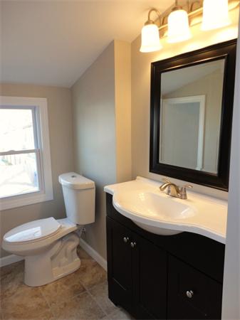 21 Anne Street Springfield, MA 01104 - Photo 20 of 27 a bathroom with a toilet sink and mirror