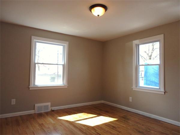 21 Anne Street Springfield, MA 01104 - Photo 22 of 27 a view of an empty room with wooden floor and a window