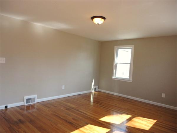 21 Anne Street Springfield, MA 01104 - Photo 9 of 27 a view of empty room with wooden floor and fan