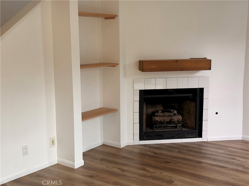 950 West Lambert Road, Unit 11 La Habra, CA 90631 - Photo 16 of 32 Fireplace and bookshelf in living space
